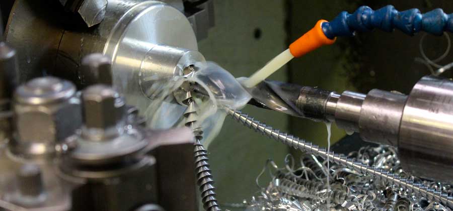 water being sprayed on to drill bit, while drilling metal